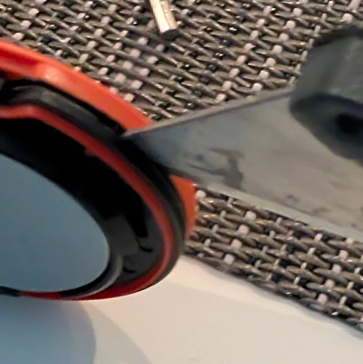 Prying open the Moto Tag 2 casing seam with a blade